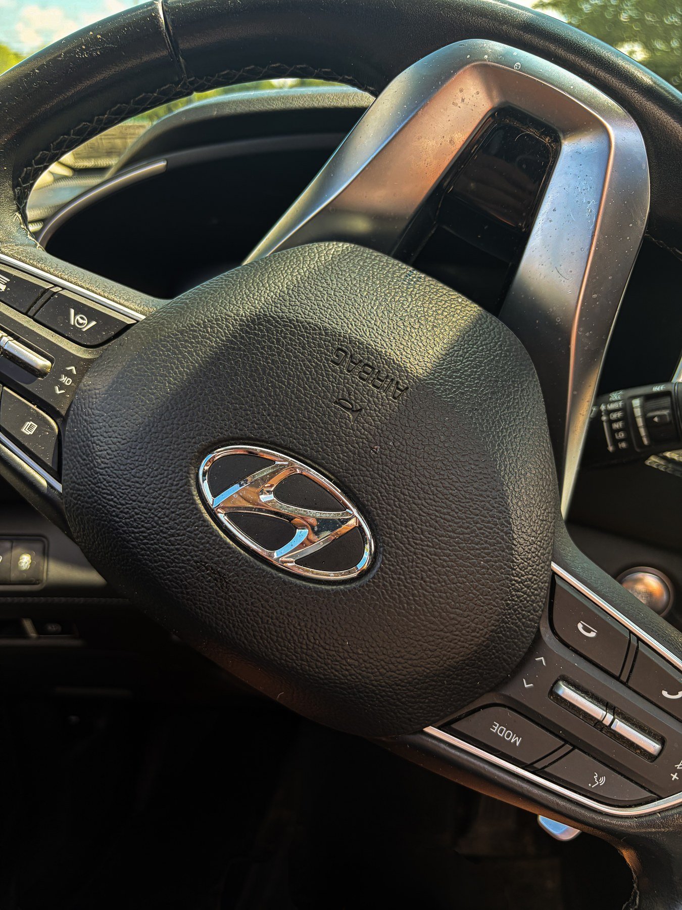 Steering wheel and driver controls inside the Hyundai Santa Fe